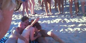 couple fucks at the beach, soon there's a crowd watching and fucking