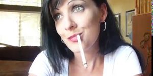 sexy brunette dangles her cigarette