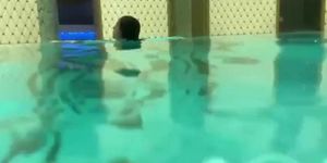 Girl swimming underwater in pool