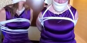 Two girls struggle in bondage
