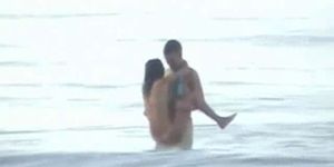 Young attractive couple fucks in the sea