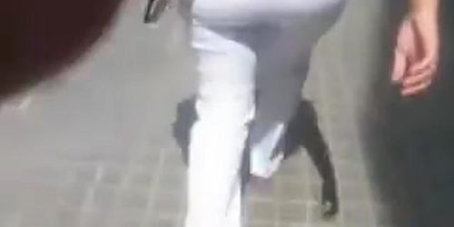 Hot street candid video of a mature women in white pants