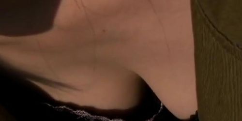 Japanese dark haired downblouse wearing a revealing black dress