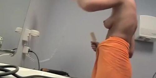 Topless girl in changing room drying out her hair