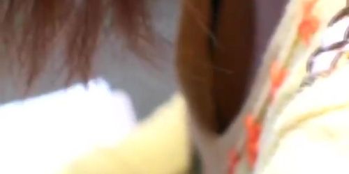 Chubby redhead Japanese shows her cleavage on candid cam video