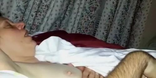 Showing off a tattoo over her hairy pussy