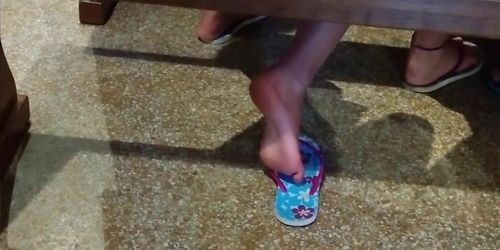 Candid girl shoeplay in flip flops