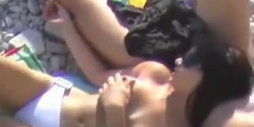 Busty woman engrossed sucking cock on the beach