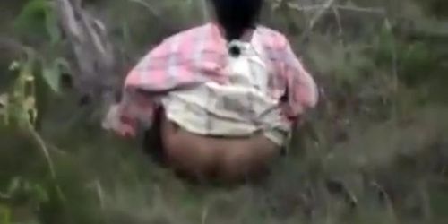 Indian women pissing in the grass in voyeur video