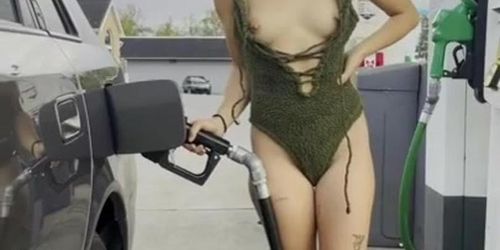 cutie flashes boobs while pumping gas