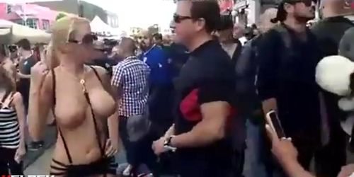 girl shows crowd her big boobs