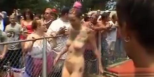 Large-breasted models pose and dance at an outdoor party