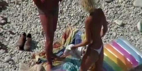 Couple undressing in beach