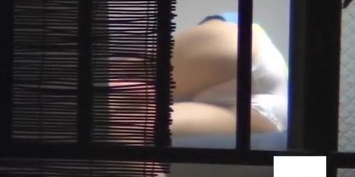 Asian girl dries out hair and masturbates on window spy cam