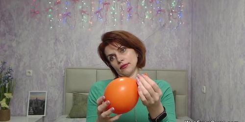 Redhead Milf plays with balloon on webcam