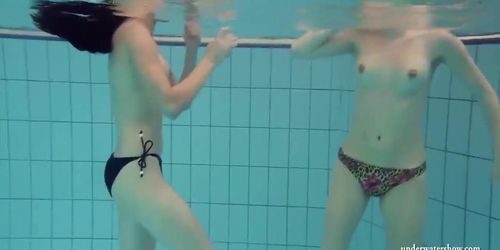 Mia and Petra undress eachother in the swimmingpool