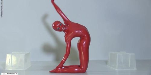 Flexible slut in a red latex catsuit