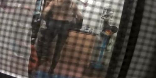 Spy camera catches neighbor in her bedroom undressing