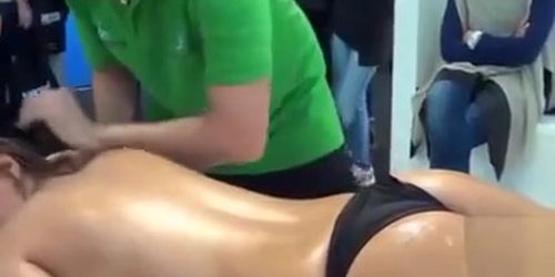 Topless girl receives a sensual educational massage in public