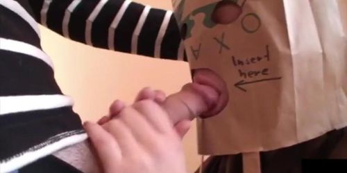 Busty Young Girl Gives Blowjob with a Paper Bag on Her Head