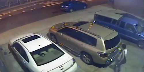 Security camera catches a girl peeing behind a car