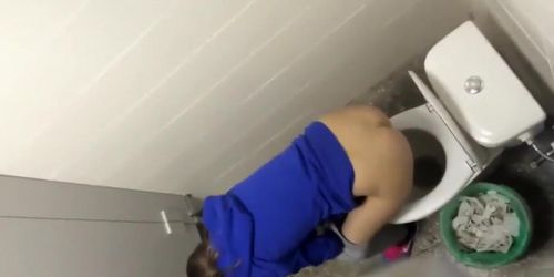 Russian girls in winter clothes gets taped while peeing in the street toilet