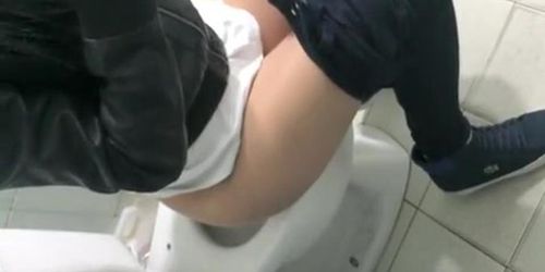 Girl cleans the toilet seat and pees