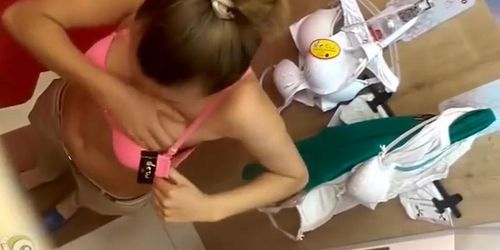 Dressing room spy films a girl trying on bras