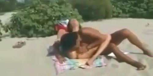 Two lesbians finger and lick each other on the beach