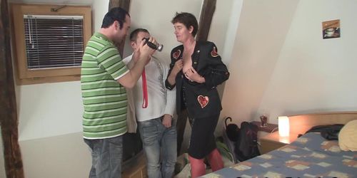 Mature woman takes two cocks on camera