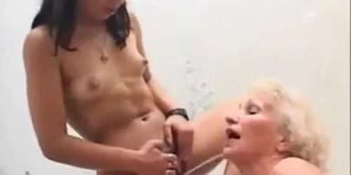 Two men and a young girl pissing in granny’s mouth