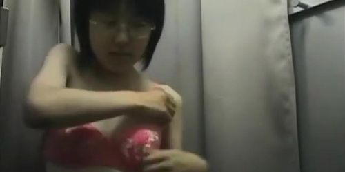 Hidden camera in changing room shows a hot bodied Asian girl.