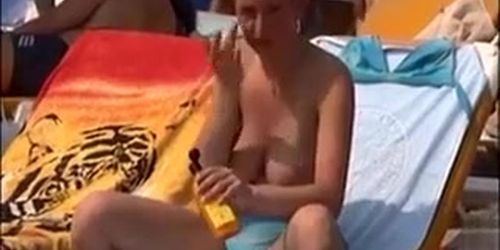 Big natural tits tanning at the beach