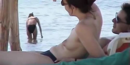 Topless babes getting caught on tape while acting naughty on the public beach