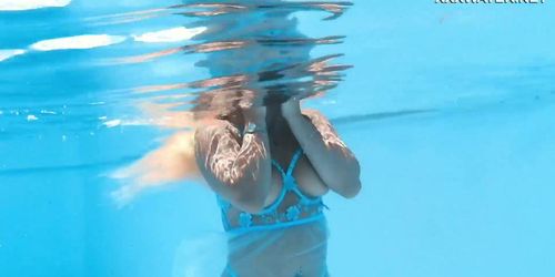 Her body cutting through the shimmering water of the pool