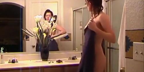 Housewife takes a shower and masturbates in voyeur clip