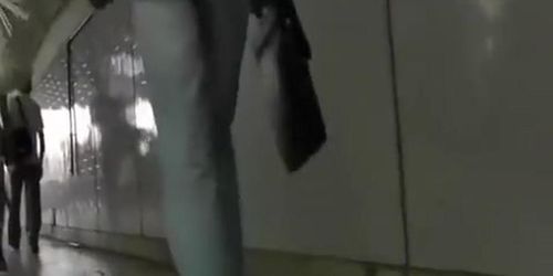 Blonde woman in short white dress upskirt