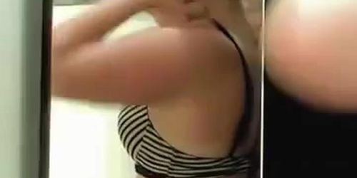Spy cam woman in change room choosing the brassiere
