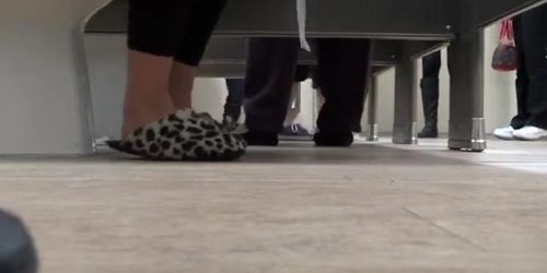 Female feet and shoes in the public toilet