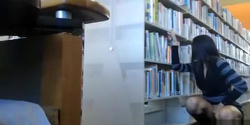 Female student makes upskirt selfie in library