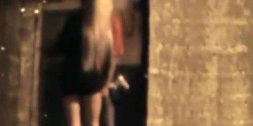 Leggy slut spied sucking cock in an alley