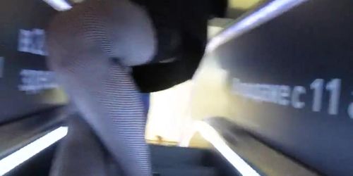 Flashing fishnet stockings tops on escalator