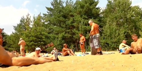 Wives and their husbands sunbathing at the nudist beach