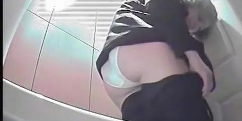 A milf pissing in the toilent to a voyeur spy cam