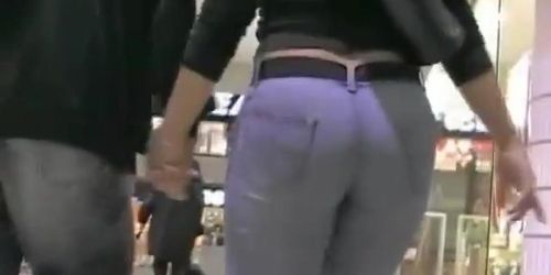 Big booty in blue jeans in a shopping mall candid video