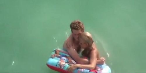 Topless chick with small tits in the water