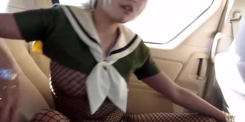 Japanese in fishnet body stocking smoking in car