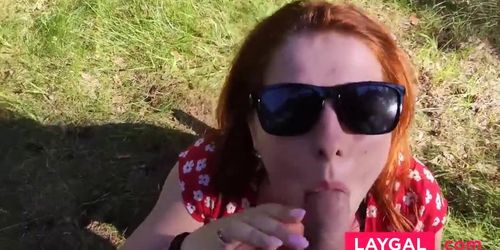 Kinky redhead with big tits gives a blowjob outdoors