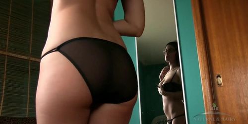 Mitena strips down in front of a mirror