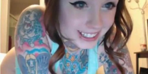 Tattooed Cutie playing with glass dildo